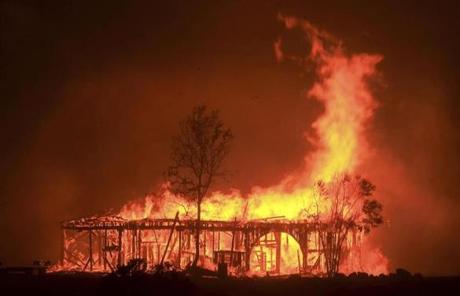 WILDFIRES SLIDER The Historic Round Barn burns, Monday Oct. 9, 2017, in Santa Rosa, Calif. More than a dozen wildfires whipped by powerful winds been burning though California wine country. The flames have destroyed at least 1,500 homes and businesses and sent thousands of people fleeing. (Kent Porter/The Press Democrat via AP)
