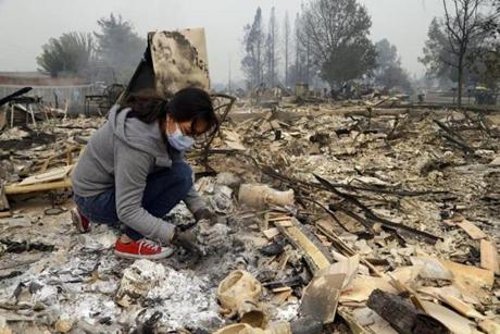 Leslie Garnica searched for belongings in the ashes of her home that was destroyed by fire in the Coffey Park area of Santa Rosa, Calif., on Tuesday.
