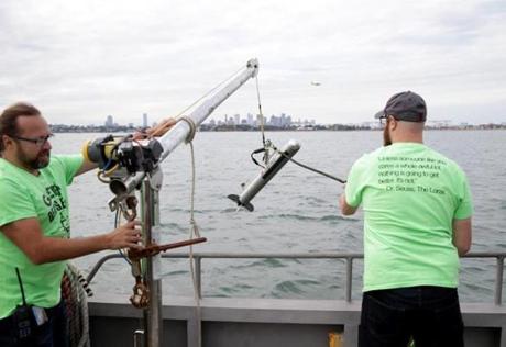 Francesco Peri, left, and Daniel Genest, right, aboard the M/V Columbia Point during during a HUBweek event Wednesday on technology and harbor health. Here they were deploying side scan sonar to demostrate their research. 
