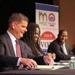 Boston Mayor Martin J. Walsh (left) and City Councilor Tito Jackson (right) at a debate moderated by the Globe?s Adrian Walker (center) at Hibernian Hall in Roxbury.