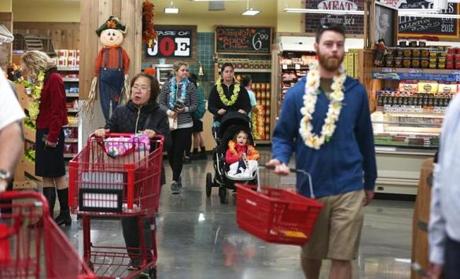 Opening-day customers at the Trader?s Joes in Allston got leis to wear;
