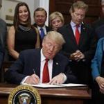 President Trump signed an executive order on health care in the Roosevelt Room of the White House on Thursday.