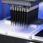 A battery of pipettes on a robot used for DNA gene sequencing in a lab. 