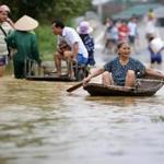People navigated a flooded area in Hanoi on Friday, after days of heavy rain caused widespread flooding.