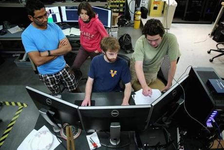 BLACKSBURG, VA - MAY 27: Virginia Tech mechanical engineering students (L-R) Lakshitha Dantanarayana, Chris Nogales, James Burton and James Paterson work all night to test the ESCHER robot the TREC (Terrestrial Robotics Engineering and Controls) Lab May 27, 2015 in Blacksburg, Virginia. Unlike many of the other 24 international teams competing in the Defense Advanced Research Projects Agency (DARPA) Robotics Challenge, the students of Team Valor have built most of the semi-autonomous ESCHER (Electromechanical Series Compliant Humanoid for Emergency Response) robot from the ground up over the last three months. The winner of the simulated disaster-response course will take home a $2 million prize next week in Pomona, California. (Photo by Chip Somodevilla/Getty Images)

