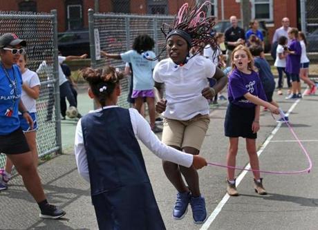 Fourth-grader Juan Taylor wound up for the throw during recess for students from Eliot School in the North End.
