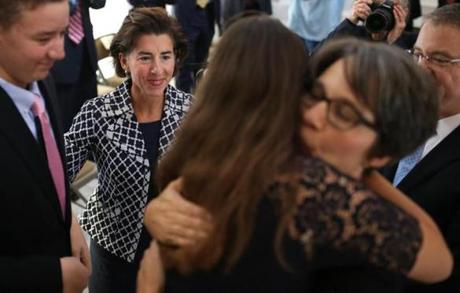 Rhode Island Governor Gina M. Raimondo (left) after giving the oath of office last week at a swearing in ceremony for Melissa A. Long (in glasses) as an associate justice of the Rhode Island Superior Court. 
