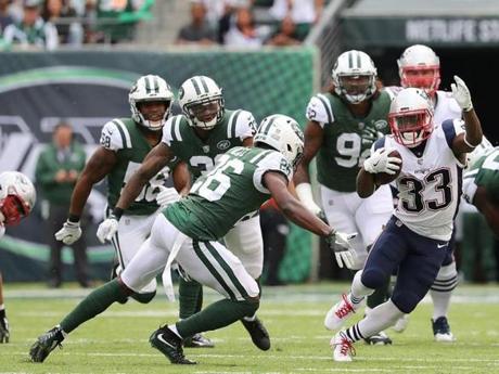 East Ruthford NJ 10/15/17 New England Patriots Dion Lewis puitting a move on New York Jets Marcus Maye during first quarter action at MetLife Stadium. (Matthew J. Lee/Globe staff) Topic: Reporter: 
