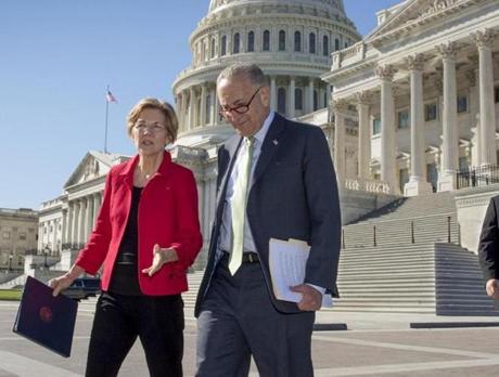 Sen. Elizabeth Warren, D-Mass., left, and Senate Minority Leader Chuck Schumer, D-N.Y., walk to a news conference on the Republican tax and budget proposals, at the Capitol in Washington, Wednesday, Oct. 18, 2017. (AP Photo/J. Scott Applewhite)
