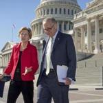 Sen. Elizabeth Warren, D-Mass., left, and Senate Minority Leader Chuck Schumer, D-N.Y., walk to a news conference on the Republican tax and budget proposals, at the Capitol in Washington, Wednesday, Oct. 18, 2017. (AP Photo/J. Scott Applewhite)