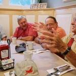 (Left to right) Bob Wiser, Bill Woolen, and Mark Zivan listened as Roger Putman shared a story while having breakfast at the Fairway Restaurant in Eastham.