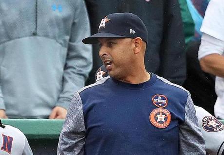 Boston, MA: October 9, 2017: Former Red Sox infielder Alex Cora (right) has been mentioned as a possible replacement for fired Boston manager John Farrell (not pictured). Cora, shown in the visitor's dugout at Fenway Park, is currently the bench coach for Houston Astros manager A.J. Hinch (left). The Boston Red Sox hosted the Houston Astros in Game Four of an ALDS baseball game at Fenway Park. (Jim Davis/Globe Staff). 
