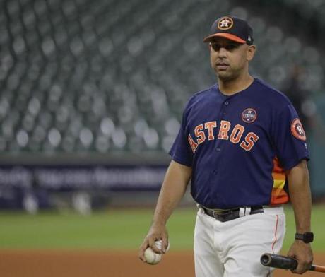 Houston Astros bench coach Alex Cora watches batting practice before Game 6 of the American League Championship Series baseball game against the New York Yankees Friday, Oct. 20, 2017, in Houston. (AP Photo/David J. Phillip)
