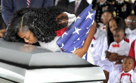 Myeshia Johnson, the wife of Army Sgt. La David Johnson, kissed her husband's casket during his funeral service at the Hollywood Memorial Gardens in Hollywood, Fla., Saturday. 
