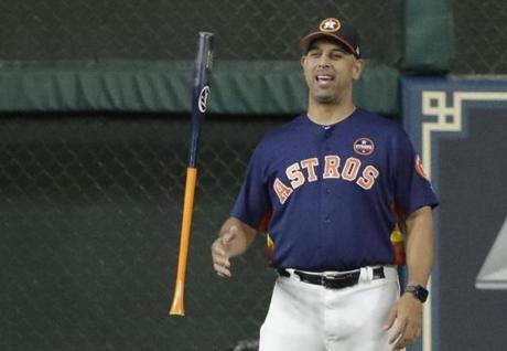Houston Astros bench coach Alex Cora flips a bat before Game 6 of the American League Championship Series baseball game against the New York Yankees Friday, Oct. 20, 2017, in Houston. (AP Photo/David J. Phillip)
