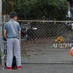 Neighborhood children looked at the memorial to the 7-year-old boy who was mauled to death Saturday in Lowell.