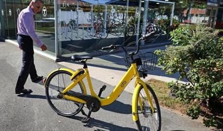 Felice Gammella looked at the Ofo bike at a T-stop in East Boston by Lewis Street.  
