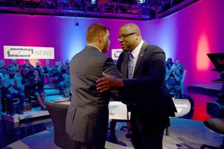 Mayor Martin J. Walsh (left) and Councilor Tito Jackson (right) at a mayoral debate before a live audience Tuesday night. 
