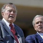 Former US Presidents George H.W. Bush and George W. Bush attend the George W. Bush Presidential Center dedication ceremony in Dallas, Texas, in April 2013.