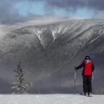 A skier looks out over the White Mountains before skiing on opening day at Loon Mountain ski resort Wednesday, Nov. 23, 2016, in Lincoln,N.H. Many ski areas in Northern New England plan to open for the Thanksgiving weekend. (AP Photo/Jim Cole)