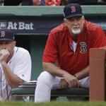 FILE - In this Oct. 9, 2017, file photo, Boston Red Sox bench coach Gary Disarcina, left, and pitching coach Carl Willis watch from the dugout during the sixth inning in Game 4 of baseball's American League Division Series against the Houston Astros, in Boston. The Cleveland Indians have hired Carl Willis as their pitching coach to replace Mickey Callaway, who left to manage the New York Mets. Willis is back for his second stint with the club. He served as Cleveland's pitching coach from 2003-09, when he tutored Cy Young pitchers CC Sabathia and Cliff Lee among others. The 56-year-old Willis spent the past two seasons with the Boston Red Sox. (AP Photo/Charles Krupa, File)