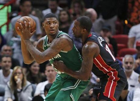 Boston Celtics guard Marcus Smart (36) looks for an open teammate past Miami Heat guard Dion Waiters (11) during the first half of an NBA basketball game, Saturday, Oct. 28, 2017, in Miami. (AP Photo/Wilfredo Lee)
