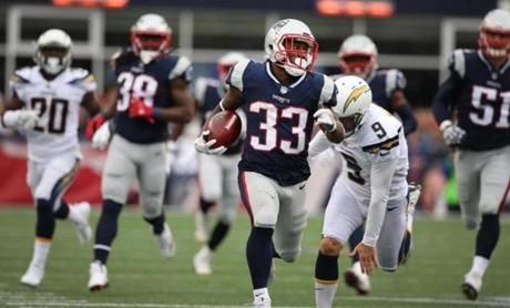 Patriots running back Dion Lewis runs for a big gain during 3rd quarter action against the L.A. Chargers at Gillette Stadium. Jim Davis/Globe staff
