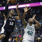 San Antonio Spurs' LaMarcus Aldridge (12) shoots against Boston Celtics' Al Horford (42) during the first quarter of an NBA basketball game in Boston, Monday, Oct. 30, 2017. (AP Photo/Michael Dwyer)