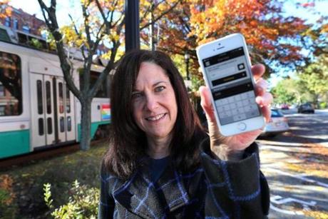 Judy White held her phone which was displaying the parking app that she used. 
