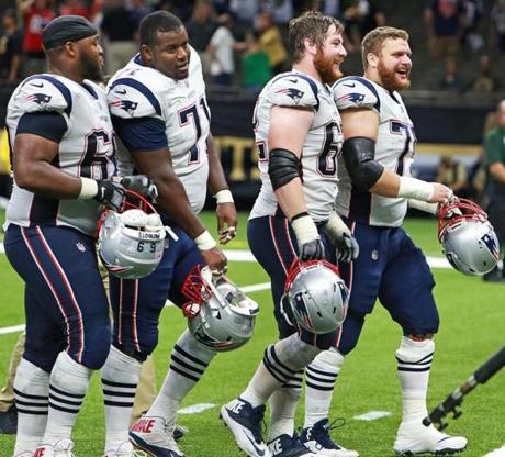 New Orleans, LA: September 17, 2017: Patriots offensive linemen, left to right, Shaq Mason, Cameron Fleming, Joe Thuney and Ted Karras are all smiles as they leave the field following New England's victory. The New England Patriots visited the New Orleans Saints in a regular season NFL football game at the Mercedes-Benz Superdome. (Jim Davis/Globe Staff). 
