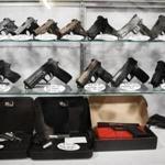 Guns are displayed behind glass in a vault for security Tuesday, Oct. 31, 2017, at CTR Firearms in Janesville, Wis. (Angela Major/The Janesville Gazette via AP)