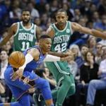 Oklahoma City Thunder guard Russell Westbrook (0) loses the ball in front of Boston Celtics guard Kyrie Irving (11) and forward Al Horford (42) during the fourth quarter of an NBA basketball game in Oklahoma City, Friday, Nov. 3, 2017. Boston won 101-94. (AP Photo/Sue Ogrocki)