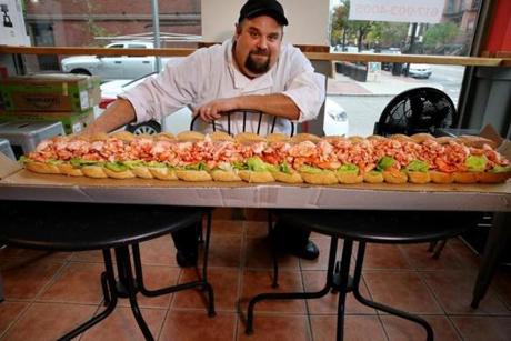 Chef Kenny Dupree poses with a 5-foot Monstah roll at Lobstah on a Roll in Boston Wednesday.
