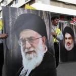Hezbollah supporters carry posters of the head of the Lebanese Shiite movement Hezbollah, Hasan Nasrallah (R) and Iran's Supreme Leader Ayatollah Ali Khamenei as they walk in the southern Lebanese city of Nabatieh on November 8, 2017 during the funeral of three Hezbollah fighters killed in combat in Syria. / AFP PHOTO / Mahmoud ZAYYATMAHMOUD ZAYYAT/AFP/Getty Images