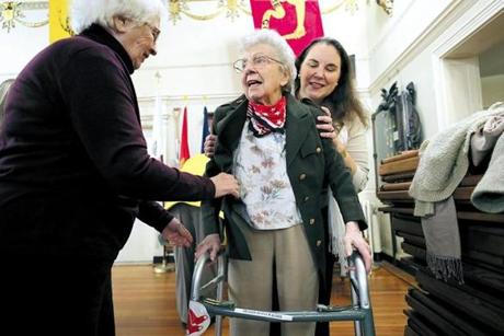 Boston, Ma., 11/10/17, Ninety-three-year old Eva Wagner, WW2 veteran, First Lieutenant with the US Army Nurse Corps, gets help from her family getting into her actual uniform from WW2. She was one of the speakers at the town hall meeting. On the left is her niece Gloria Webster, on right is great neice Kira Jacobs. Boston Veteran Services and Brighton Marine held a Special Veterans Day Town Hall at the Ancient and Honorable Artillery Museum in Faneuil Hall. It is part of a National Veterans Town Hall Initiative conceived by Congressman Seth Moulton, a veteran himself, and author Sebastian Junger, who has written about the importance of veterans sharing their experiences with their communities. It is a community forum aiming to establish a greater understanding between local veterans and the friends and neighbors they fought for. Globe staff/Suzanne Kreiter

