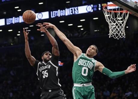 Boston Celtics' Jayson Tatum (0) blocks a shot by Brooklyn Nets' Trevor Booker (35) during the first half of an NBA basketball game Tuesday, Nov. 14, 2017, in New York. (AP Photo/Frank Franklin II)
