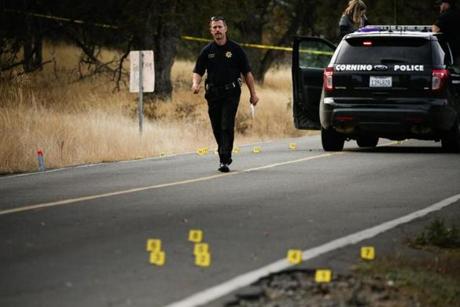 A law enforcement officer is seen at one of many crime scenes after a shooting on Tuesday.
