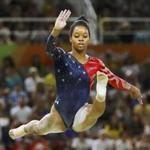 Gabrielle Douglas competes on the beam during the women's qualifications at the 2016 Rio Olympics.