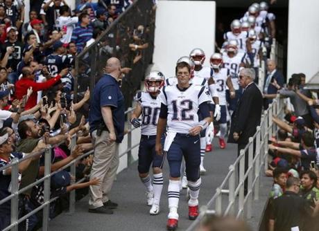 Mexico City, Mexico -- 11/19/2017 - New England Patriots quarterback Tom Brady leads the team out onto the field against the Oakland Raiders during the first half of their 2017 NFL Mexico Game at the Estadio Azteca. (Jessica Rinaldi/Globe Staff) Topic: Patriots Reporter: 
