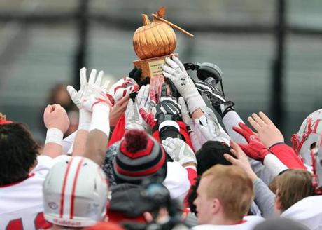 Boston MA 11/24/16 Catholic Memorial players reaching to touch the trophy after they defeated Boston College High during Thanksgiving Day football at Boston College High. (Photo by Matthew J. Lee/Globe staff) topic: 25bchigh reporter:
