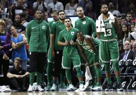 Boston Celtics' Terry Rozier, second from right, and Marcus Morris (13) watch during the second half of an NBA basketball game against the Miami Heat, Wednesday, Nov. 22, 2017, in Miami. The Heat won 104-98. (AP Photo/Lynne Sladky)
