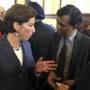 Rhode Island Gov. Gina Raimondo, left, and Infosys President Ravi Kumar, center, speak after a news conference, Monday, Nov. 27, 2017, in Providence, R.I., announcing the India-based information technology outsourcing firm will open a design and innovation hub in the state and plans to add 500 jobs there in the next five years. (AP Photo/Michelle R. Smith)