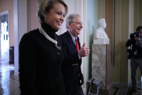 Senate Majority Leader Mitch McConnell (R-KY) gives a thumbs-up as he and his Director of Operations Stephanie Muchow head for the Senate floor at the U.S. Capitol on Friday.

