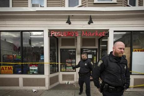 Officers were at Peguero?s Market in Dorchester on Saturday after an employee was shot to death there Friday night.

