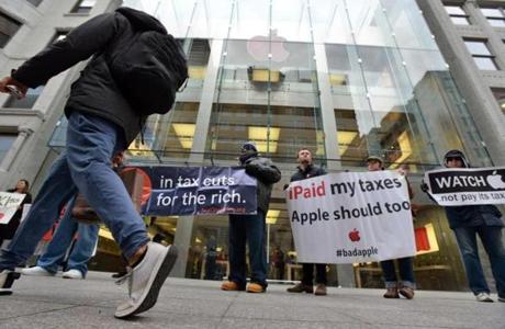 Protesters Saturday rallied against the bill and against corporations they say avoid taxes, such as Apple.
