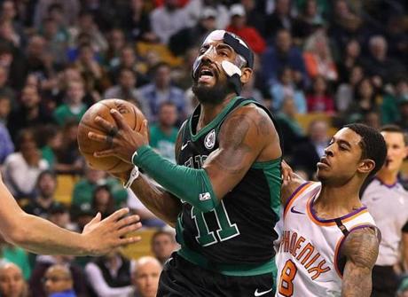 Boston-12/02/17- Celtics vs Suns- Celtics Kyrie Irving drives past Suns Tyler Ulis in the 4th qtr for a layup. John Tlumacki/Globe Staff(sports)
