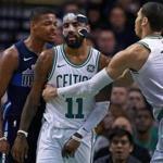 Boston, MA: 12-06-17: The Mavericks Dennis Smith Jr. (left) and the Celtics Kyrie Irving (11) had an incident under the basket in the first quarter that saw both get technical fouls called on them. Boston's Jayson Tatum (0), moves in to pull Irving away. The Boston Celtics hosted the Dallas Mavericks in a regular season NBA basketball game at the TD Garden. (Jim Davis/Globe Staff)
