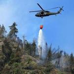 A helicopter dropped water in the White Mountains in Woodstock, N.H., in October. 