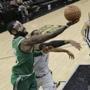 Boston Celtics guard Kyrie Irving (11) shoots past San Antonio Spurs forward LaMarcus Aldridge (12) during the second half of an NBA basketball game Friday, Dec. 8, 2017, in San Antonio. (AP Photo/Eric Gay)