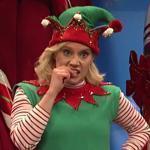 Kate McKinnon as Amy the Elf tries to help Santa, played by Kenan Thompson, answer some difficult questions from children. 